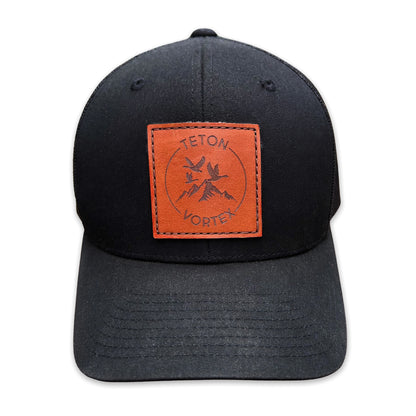 Black cap with a brown leather patch featuring Teton Vortex logo on a white background