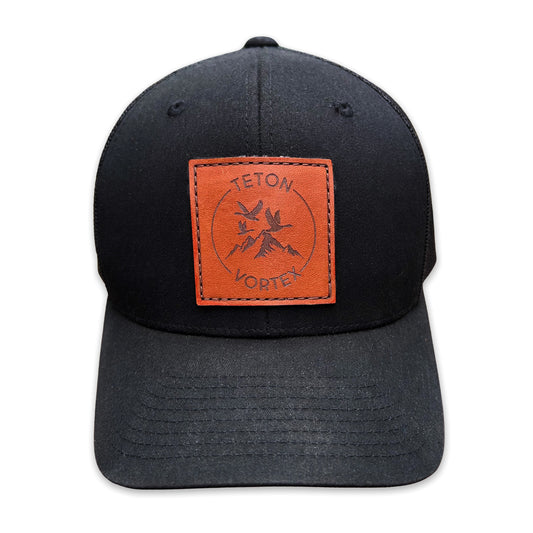 Black cap with a brown leather patch featuring Teton Vortex logo on a white background